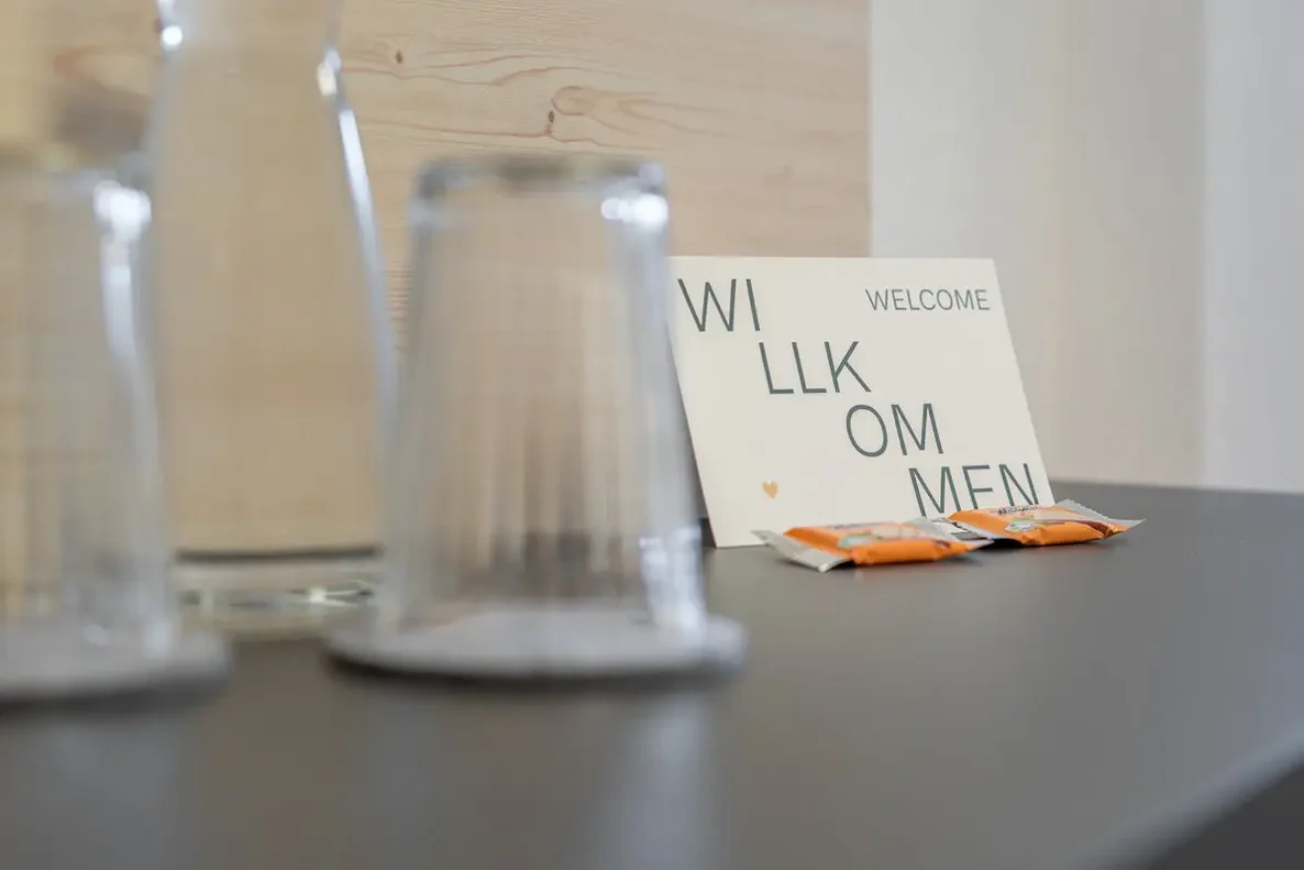 Room detail at Haus Gstrein, featuring a welcome card and glasses