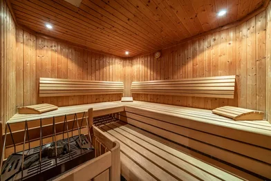 Sauna at Haus Gstrein with wooden benches and a sauna stove